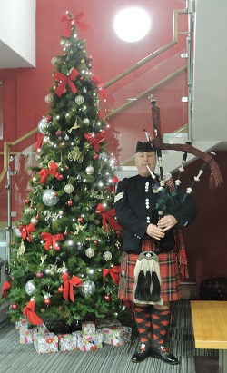 Scottish Bagpiper performing at a Hogmanay celebration